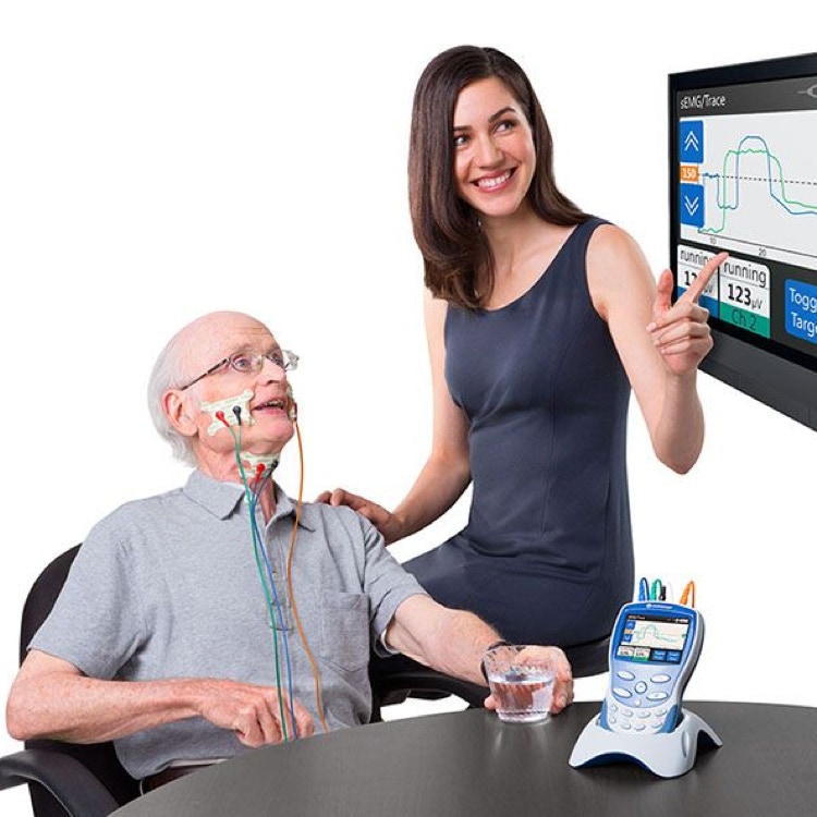Concentrated female therapist giving foot massage to anonymous patient lying on table with towel during spa procedure on blurred background