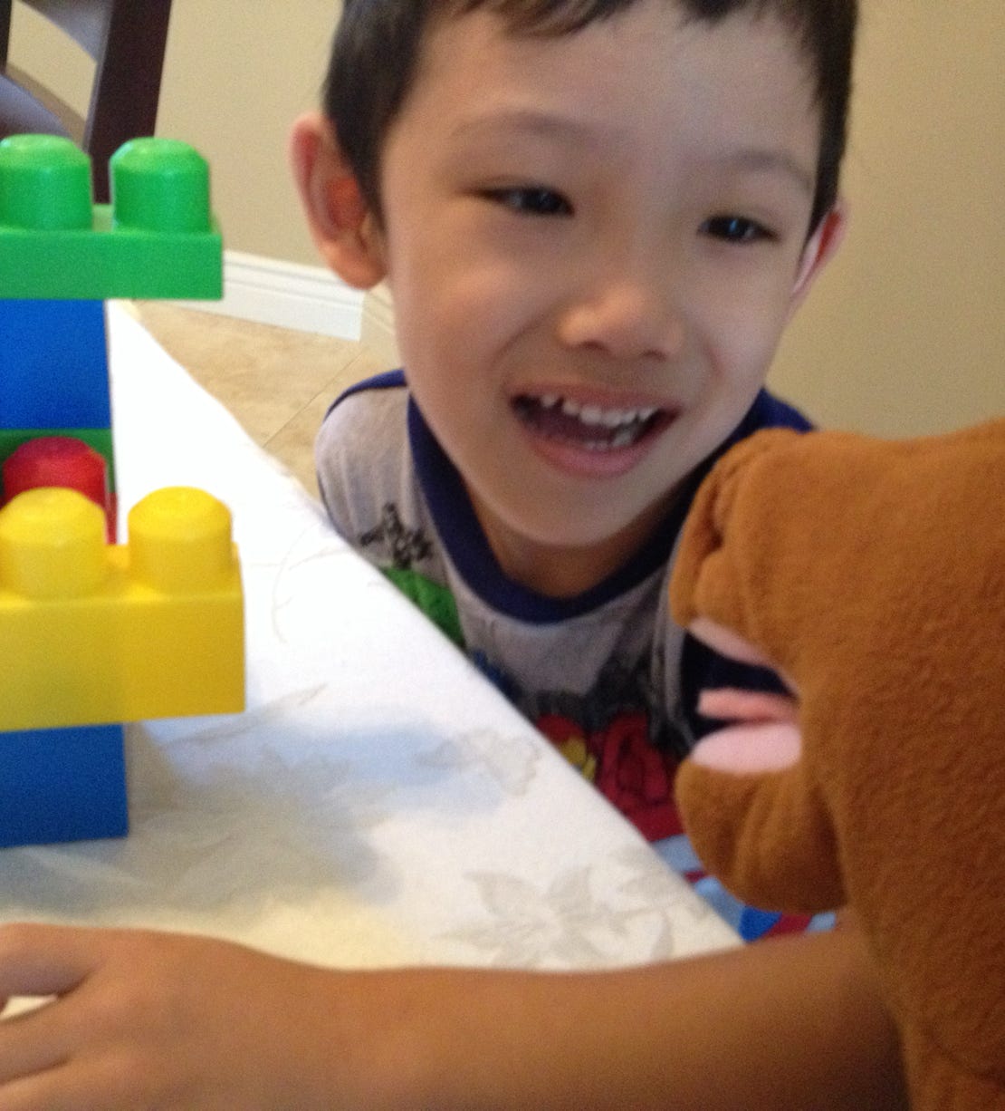Boy with speech therapist with horse puppet